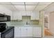 A functional kitchen with white cabinetry, tile flooring, and modern appliances at 14130 Rosemary Ln # 4115, Largo, FL 33774
