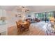 Cozy living room featuring a ceiling fan, dining area, sliding glass doors to patio, and comfortable furnishings at 14130 Rosemary Ln # 4115, Largo, FL 33774