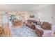 Bright living area with a sofa, dining table, ceiling fan, sliding doors to lanai, and view of the water at 14130 Rosemary Ln # 4115, Largo, FL 33774