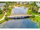 Aerial view of a bridge over a pond with buildings and landscaping in the surrounding community at 14130 Rosemary Ln # 4115, Largo, FL 33774