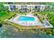 Gorgeous swimming pool surrounded by lounge chairs and lush landscaping in a condo community at 14130 Rosemary Ln # 4115, Largo, FL 33774
