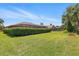 Sprawling backyard with well-maintained lawn and lush privacy hedge, perfect for outdoor enjoyment at 14168 Fennsbury Dr, Tampa, FL 33624