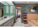 Bathroom with large vanity, bathtub, decorative mirror, and doorway to Primary bedroom at 14168 Fennsbury Dr, Tampa, FL 33624