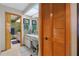 Bathroom features double sink vanity, tile floors, and decorative mirror at 14168 Fennsbury Dr, Tampa, FL 33624