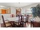 Bright dining room boasting hardwood floors, traditional furniture, and a charming chandelier at 14168 Fennsbury Dr, Tampa, FL 33624
