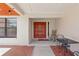 Welcoming front porch featuring a double door entry, red brick pathway and outdoor seating at 14168 Fennsbury Dr, Tampa, FL 33624
