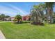 Beautifully landscaped front yard with mature palm trees and a charming, well-maintained residence at 14168 Fennsbury Dr, Tampa, FL 33624
