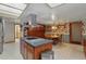 Open kitchen includes a central island, stove top, modern vent hood and adjacent eat-in dining area at 14168 Fennsbury Dr, Tampa, FL 33624
