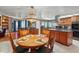 View of kitchen features an island, breakfast table and dark wood cabinetry at 14168 Fennsbury Dr, Tampa, FL 33624