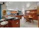Spacious kitchen with breakfast bar, dining area, and dark wood cabinets at 14168 Fennsbury Dr, Tampa, FL 33624
