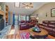 Open living room with fireplace, vaulted ceiling, and hardwood floors and leads to kitchen at 14168 Fennsbury Dr, Tampa, FL 33624