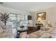 Relaxing living room with sliding glass doors to the lanai, and a comfortable seating arrangement at 14168 Fennsbury Dr, Tampa, FL 33624