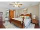 Bright main bedroom features hardwood floors, ceiling fan, and ensuite bathroom access at 14168 Fennsbury Dr, Tampa, FL 33624