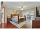 Hardwood floors, ceiling fan, and sliding glass doors to outdoor patio in spacious main bedroom at 14168 Fennsbury Dr, Tampa, FL 33624