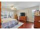 Large main bedroom with hardwood floors, ceiling fan, and sliding glass doors to outdoor patio at 14168 Fennsbury Dr, Tampa, FL 33624