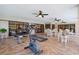 Bright patio area with exercise equipment, ceiling fans, tile flooring and outdoor furniture at 14168 Fennsbury Dr, Tampa, FL 33624