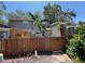 Rear exterior view showcasing a fenced yard, partial view of home, and mature foliage at 14667 Pine Glen Crk # 14667, Lutz, FL 33559