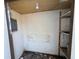 Unfinished basement with concrete block walls and ceiling with wooden shelves at 14667 Pine Glen Crk # 14667, Lutz, FL 33559
