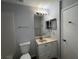 Bright bathroom featuring a vanity with modern fixtures and a convenient mirror at 14667 Pine Glen Crk # 14667, Lutz, FL 33559