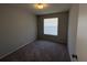 Neutral-toned bedroom with large window and neutral carpeted floors at 14667 Pine Glen Crk # 14667, Lutz, FL 33559