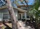 Inviting front entrance with a covered porch and lush landscaping creates an appealing curb appeal at 14667 Pine Glen Crk # 14667, Lutz, FL 33559