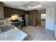 This kitchen features stainless steel appliances, tile flooring, updated counters and dark cabinets at 14667 Pine Glen Crk # 14667, Lutz, FL 33559