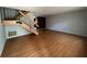 Open living room features wood laminate flooring and a wood staircase at 14667 Pine Glen Crk # 14667, Lutz, FL 33559