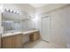 Bright bathroom features dual sinks, vanity, and a large mirror at 15006 Shaw Rd, Tampa, FL 33625