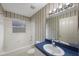 Bathroom features blue countertops and white tiled tub and shower at 15006 Shaw Rd, Tampa, FL 33625