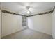 Bedroom featuring a ceiling fan, neutral carpeting, and window at 15006 Shaw Rd, Tampa, FL 33625