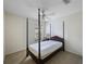 Bedroom featuring a four-poster bed frame, bright window, and a ceiling fan at 15006 Shaw Rd, Tampa, FL 33625