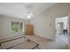 Bedroom featuring a ceiling fan, neutral carpet, and large window at 15006 Shaw Rd, Tampa, FL 33625