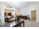 Well-lit dining room with pass-through to the kitchen and an adjacent hallway at 15006 Shaw Rd, Tampa, FL 33625