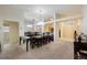 Spacious dining room with a chandelier, large mirror, and views into the kitchen and entry at 15006 Shaw Rd, Tampa, FL 33625