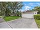 Wide view of a home's exterior, showing the lawn, landscaping, and two car garage at 15006 Shaw Rd, Tampa, FL 33625