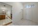 Bright and open foyer with white walls, tile flooring, and view into adjacent rooms at 15006 Shaw Rd, Tampa, FL 33625