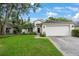 Inviting single-story home with a well-manicured lawn and an attached two-car garage at 15006 Shaw Rd, Tampa, FL 33625