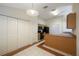 Kitchen featuring wooden cabinets, white appliances and large pantry at 15006 Shaw Rd, Tampa, FL 33625