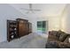 Open living room area with a ceiling fan and sliding doors to the outdoors at 15006 Shaw Rd, Tampa, FL 33625