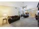 Bright open floor plan with dining and living area featuring a sofa, ceiling fan and access to the patio at 15006 Shaw Rd, Tampa, FL 33625
