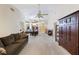 Bright open floor plan with dining and living area featuring a sofa, ceiling fan and access to the patio at 15006 Shaw Rd, Tampa, FL 33625