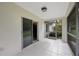 This screened porch features neutral tile flooring and lots of natural light at 15006 Shaw Rd, Tampa, FL 33625