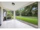 Enjoy the backyard view from this tiled screened porch at 15006 Shaw Rd, Tampa, FL 33625