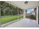 The screened lanai offers a view of the green backyard at 15006 Shaw Rd, Tampa, FL 33625