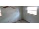 Vacant bedroom with two windows, peeling paint, baseboards, and dirty floors in need of repair at 1785 42Nd S St, St Petersburg, FL 33711
