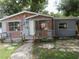 Modest one story home with brick facade, small front porch and green yard in need of TLC at 1785 42Nd S St, St Petersburg, FL 33711