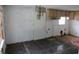 Kitchen and dining area with older cabinetry, tile floors, and damage to drywall at 1785 42Nd S St, St Petersburg, FL 33711