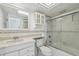 All-white bathroom with shower and bath combination, decorative tile accents, and built in storage at 17900 Gulf Blvd # 16C, Redington Shores, FL 33708