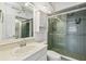 Bright bathroom with a white sink vanity, mirror and walk-in tiled shower at 17900 Gulf Blvd # 16C, Redington Shores, FL 33708