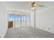 Carpeted bedroom with sliding glass doors leading to a balcony with an ocean view at 17900 Gulf Blvd # 16C, Redington Shores, FL 33708